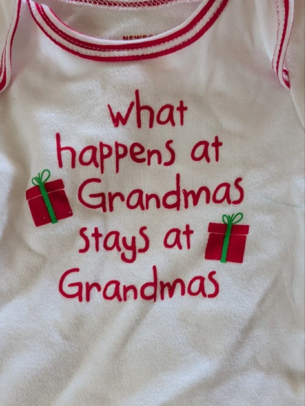 White Baby Onesie with Pink Trim and Holiday Gift Graphic